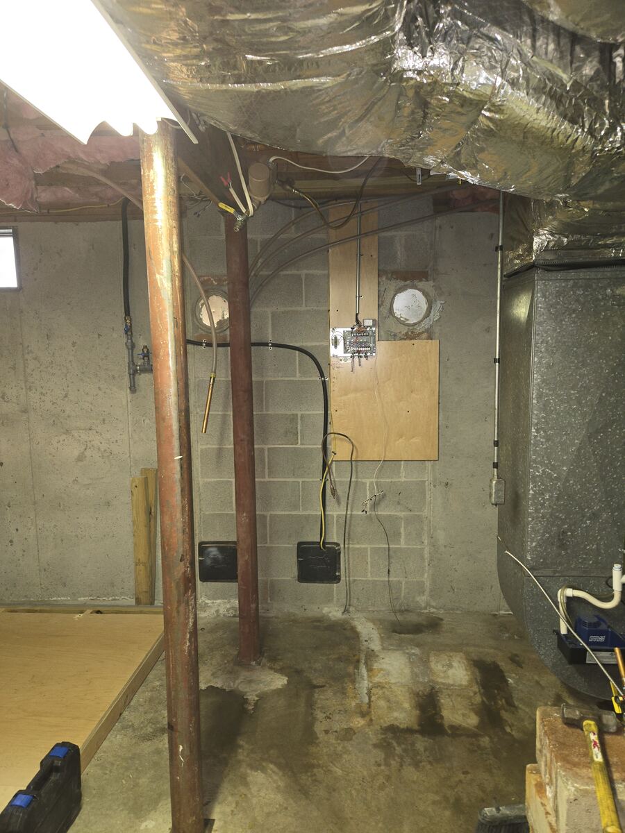 Basement corner emptied after the old water heater and boiler were removed