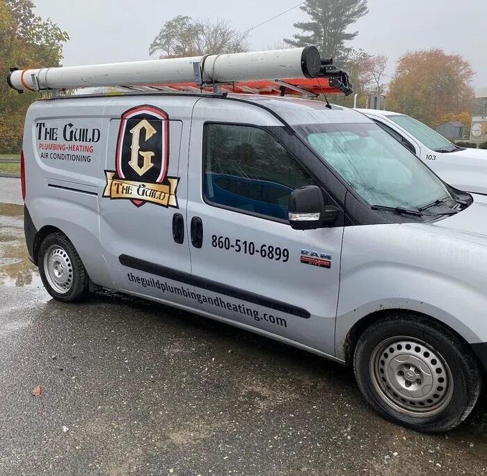 The Guild service van with the shield logo and phone number on the side